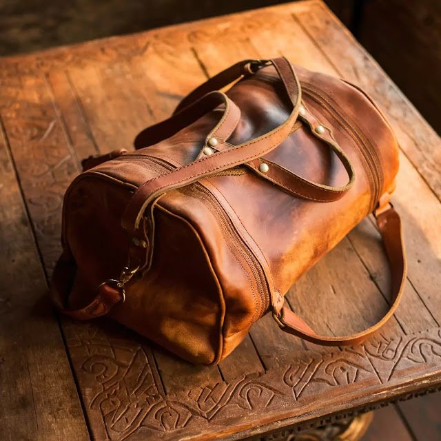 Best Prompts for Creative Advertising with Midjourney An antique leather bag with a rustic wooden table, vintage vibes