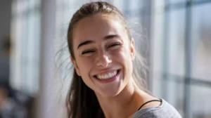 ai art prompts for realistic results - A candid close-up portrait of a young woman with a genuine, relaxed smile by AI Artz