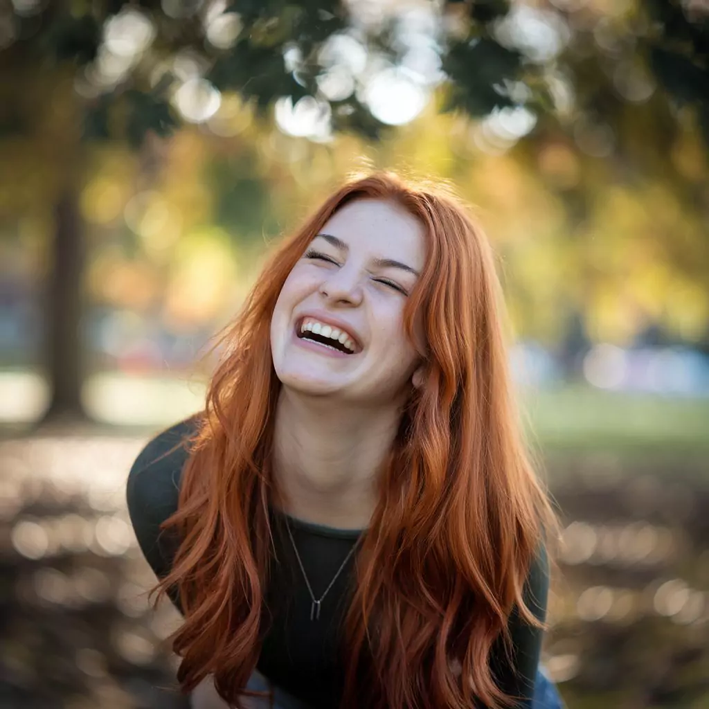 30 AI Art Prompts for Realistic Results ai art prompts for realistic results - A vibrant, expressive portrait of a young woman laughing heartily