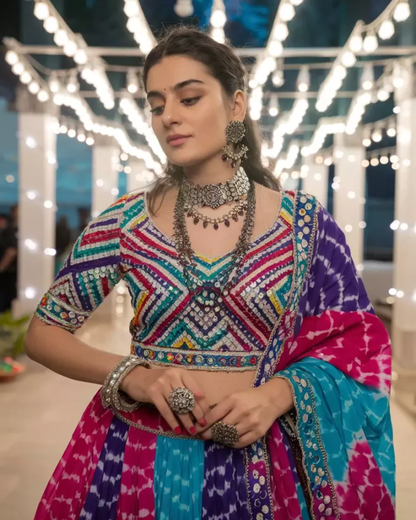 Prompts to Create Beautiful Indian Girls in Diverse Indian Attires AI-generated image of a beautiful Indian girl in a vibrant Gujarati Chaniya Choli lehenga featuring multicolored bandhani patterns, intricate mirror work, and silver jewelry, celebrating the festival of colors and the traditional fashion heritage of Gujarat by AI Artz.