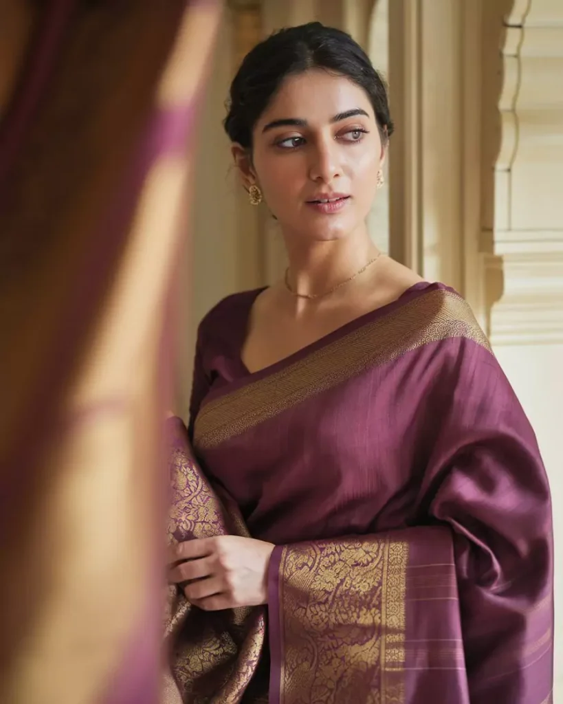 Prompts to Create Beautiful Indian Girls in Diverse Indian Attires AI-generated image of a beautiful Indian woman wearing a royal purple Mysore Silk saree with rich golden zari borders, styled with minimal jewelry and set in an elegant palace backdrop, reflecting Karnataka's regal legacy and luxurious textile heritage by AI Artz.