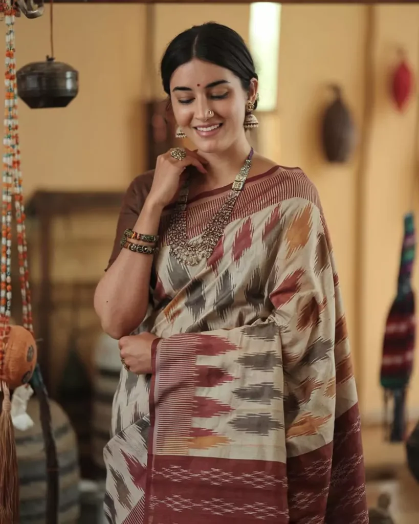 Prompts to Create Beautiful Indian Girls in Diverse Indian Attires AI-generated image of a beautiful Indian girl wearing a traditional Sambalpuri saree from Odisha, featuring distinctive tie-dye patterns and earthy colors, accessorized with silver jewelry, highlighting the artistry and cultural heritage of Odisha's iconic attire by AI Artz.
