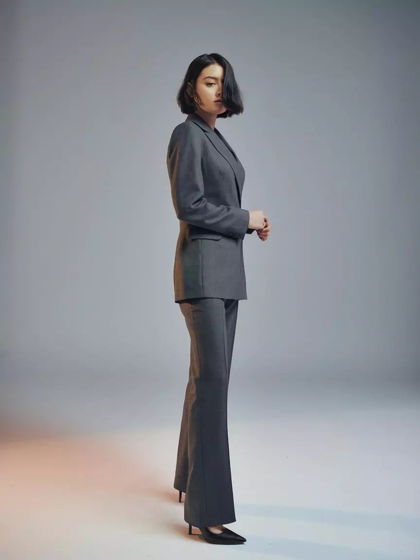 AI Art Prompt for Full Body Images in Every Style A high-resolution AI-generated image of a young woman in a professional grey suit, showcasing a full-body studio portrait created with an AI art prompt for full body by AI Artz