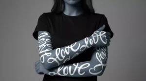 AI Prompts for Body Painting - Close-up portrait of a female model with neon bioluminescent body paint, showcasing high-relief tactile textures and glowing cyan geometric lines against a dark background by AI Artz